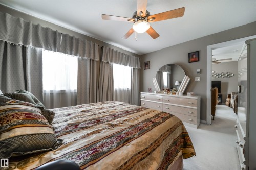 Bedroom featuring light colored carpet and ceiling fan - 237 278 Suder Greens Drive, Edmonton, AB - Indoor Photo Showing Bedroom