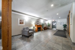 Community lobby featuring a textured ceiling and recessed lighting - 