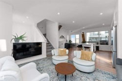 Living area with stairway, light wood-style flooring, and recessed lighting, and corner wrapped windows. - 