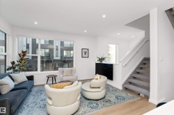 Living area with stairway, light wood-style flooring, and recessed lighting, and corner wrapped windows. - 