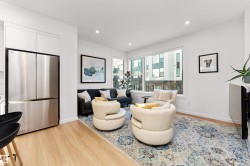 Living area with stairway, light wood-style flooring, and recessed lighting, and corner wrapped windows. - 