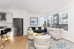 Living area with stairway, light wood-style flooring, and recessed lighting, and corner wrapped windows. - 