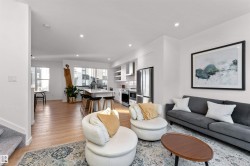 Living area with stairway, light wood-style flooring, and recessed lighting, and corner wrapped windows. - 