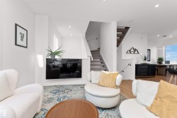 Living area with stairway, light wood-style flooring, and recessed lighting, and corner wrapped windows. - 
