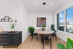 Dining area with light wood-style floors and recessed lighting, and big bright windows. - 