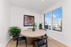 Dining area with light wood-style floors and recessed lighting, and big bright windows. - 