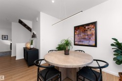 Dining area with light wood-style floors and recessed lighting, and big bright windows. - 