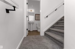 Main floor half bath near the kitchen (seperated by stairs). - 