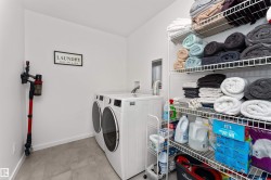 Oversized walk-in laundry room, with upgraded front loading washer and dryer & shelving unit. - 
