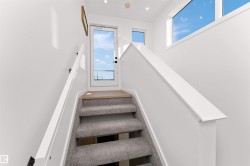 Staircase that leads to the oversized rooftop patio. This area has an extra window for beautiful sunlight. - 