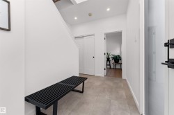 Foyer with a high ceiling and stairway on the ground level. Next to den/office and double garage entrance. - 