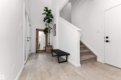 Foyer entrance featuring a towering ceiling and stairway. What a way to come home! - 