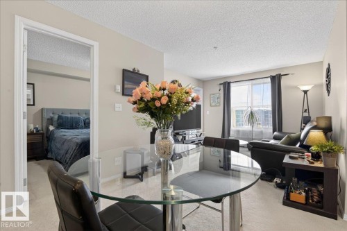 Dining space featuring a textured ceiling and baseboards - 305 12045 22 Avenue, Edmonton, AB - Indoor Photo Showing Other Room