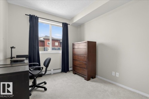Office space with light colored carpet and a textured ceiling - 305 12045 22 Avenue, Edmonton, AB - Indoor Photo Showing Office