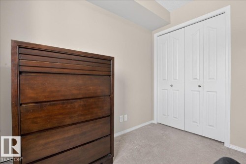 Unfurnished bedroom with light carpet and a closet - 305 12045 22 Avenue, Edmonton, AB - Indoor