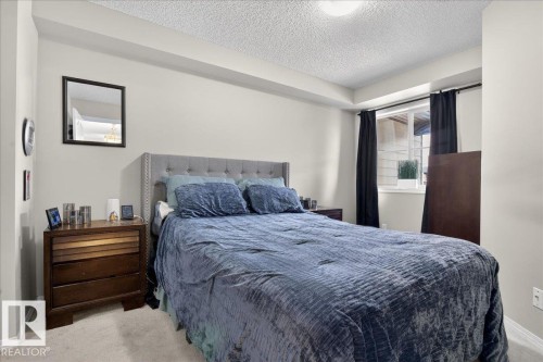 Bedroom featuring carpet flooring and a textured ceiling - 305 12045 22 Avenue, Edmonton, AB - Indoor Photo Showing Bedroom