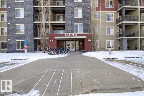 Snow covered building featuring a view of apartment building / complex - 305 12045 22 Avenue, Edmonton, AB - Outdoor With Facade