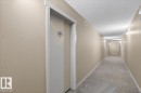 Hallway with carpet floors and a textured ceiling - 305 12045 22 Avenue, Edmonton, AB  - Indoor Photo Showing Other Room 