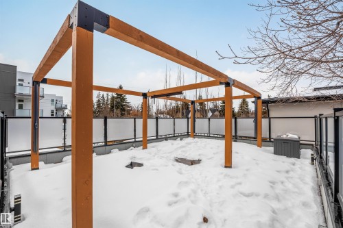 Snow covered patio with a fenced backyard - 10038 142 Street, Edmonton, AB - Outdoor