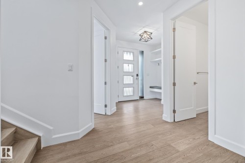 Foyer with light wood finished floors and baseboards - 10038 142 Street, Edmonton, AB - Indoor Photo Showing Other Room