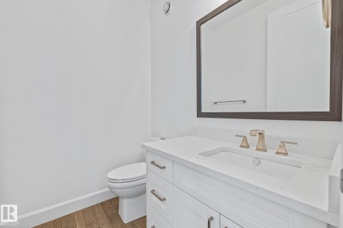 Bathroom with vanity and light wood-type flooring - 10038 142 Street, Edmonton, AB - Indoor Photo Showing Bathroom