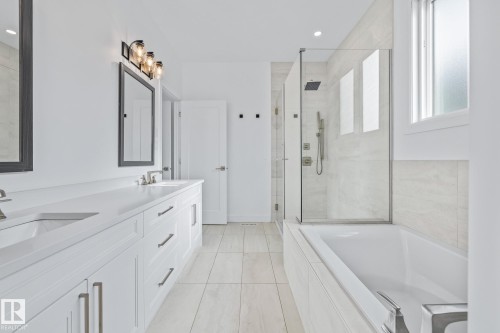 Full bath featuring a bath, a shower stall, double vanity, and recessed lighting - 10038 142 Street, Edmonton, AB - Indoor Photo Showing Bathroom