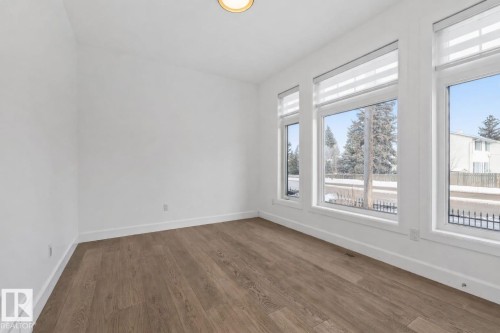 Spare room featuring dark wood-style flooring - 10038 142 Street, Edmonton, AB - Indoor Photo Showing Other Room