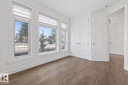Unfurnished bedroom with wood finished floors and a closet - 10038 142 Street, Edmonton, AB - Indoor Photo Showing Other Room