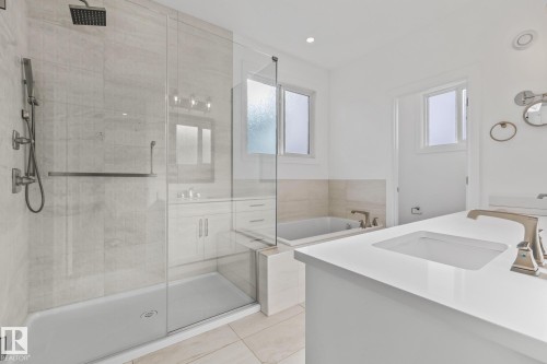 Full bath with vanity, a shower stall, a bath, and light tile patterned floors - 10038 142 Street, Edmonton, AB - Indoor Photo Showing Bathroom