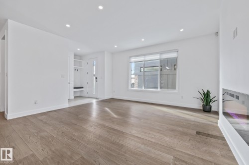 Unfurnished living room with light wood finished floors and recessed lighting - 10038 142 Street, Edmonton, AB - Indoor Photo Showing Other Room