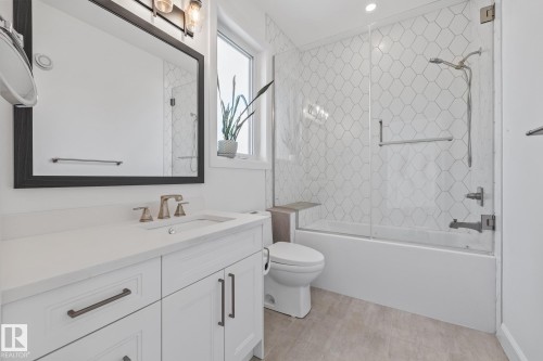 Full bath with vanity and combined bath / shower with glass door - 10038 142 Street, Edmonton, AB - Indoor Photo Showing Bathroom