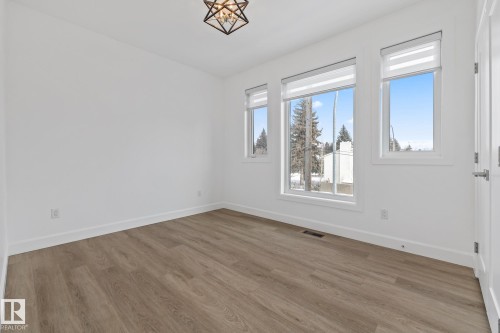 Spare room featuring baseboards and wood finished floors - 10038 142 Street, Edmonton, AB - Indoor Photo Showing Other Room