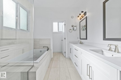 Bathroom with double vanity and a bath - 10038 142 Street, Edmonton, AB - Indoor Photo Showing Bathroom