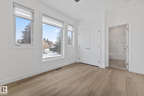 Unfurnished bedroom featuring light wood-type flooring, a closet, and connected bathroom - 10038 142 Street, Edmonton, AB - Indoor Photo Showing Other Room
