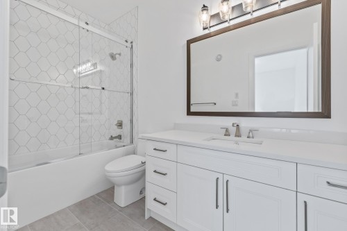 Full bathroom featuring vanity and bath / shower combo with glass door - 10038 142 Street, Edmonton, AB - Indoor Photo Showing Bathroom
