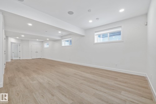 Below grade area with recessed lighting and light wood-style flooring - 10038 142 Street, Edmonton, AB - Indoor Photo Showing Other Room