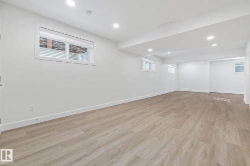 Below grade area featuring light wood-style flooring and recessed lighting - 10038 142 Street, Edmonton, AB - Indoor