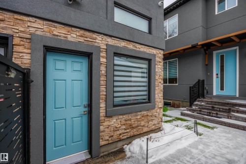 View of exterior entry with stone siding, stucco siding, and a patio area - 10038 142 Street, Edmonton, AB - Outdoor