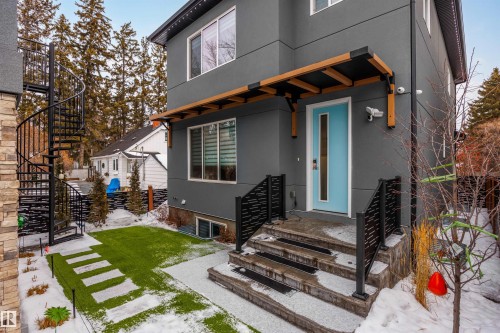 Property entrance featuring stucco siding and a patio area - 10038 142 Street, Edmonton, AB - Outdoor