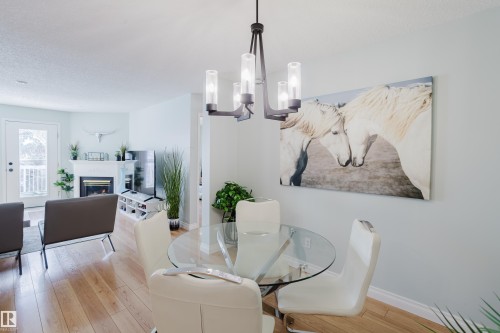 310 8907 106A Avenue, Edmonton, AB - Indoor Photo Showing Dining Room With Fireplace