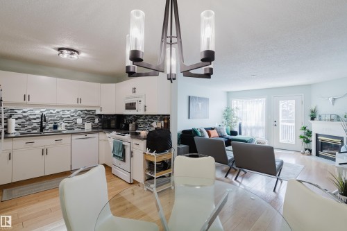310 8907 106A Avenue, Edmonton, AB - Indoor Photo Showing Kitchen With Fireplace