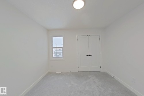 Unfurnished bedroom featuring light colored carpet and a closet - 3158 Magpie Way, Edmonton, AB - Indoor Photo Showing Other Room