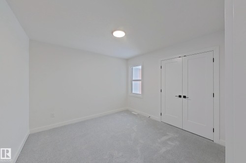 Unfurnished bedroom featuring light colored carpet and a closet - 3158 Magpie Way, Edmonton, AB - Indoor Photo Showing Other Room