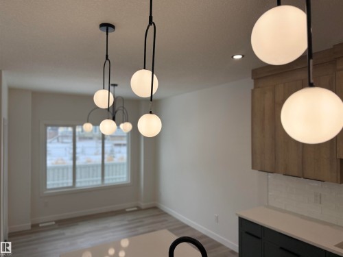 Unfurnished dining area with light wood finished floors and recessed lighting - 3158 Magpie Way, Edmonton, AB - Indoor