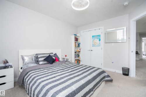 Bedroom featuring light carpet and a textured ceiling - 43 1703 16 Avenue, Edmonton, AB - Indoor Photo Showing Bedroom