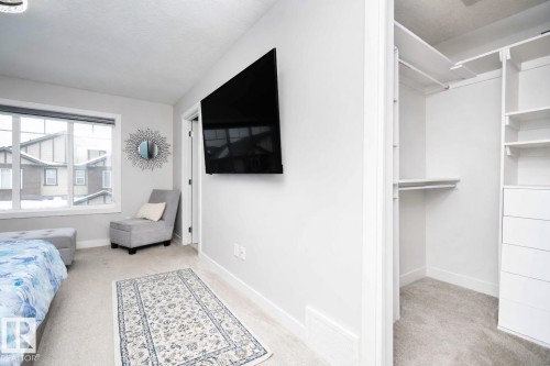 Bedroom with light carpet and baseboards - 43 1703 16 Avenue, Edmonton, AB - Indoor