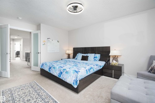 Bedroom with carpet flooring and a textured ceiling - 43 1703 16 Avenue, Edmonton, AB - Indoor Photo Showing Bedroom