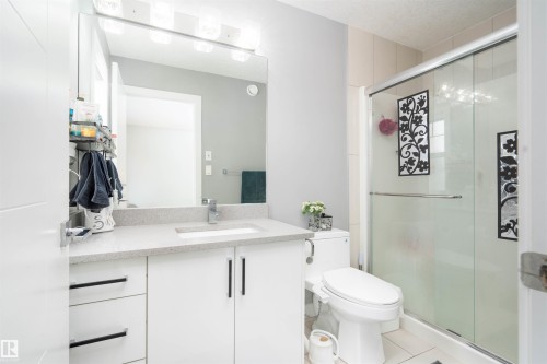 Bathroom featuring vanity, a stall shower, and light tile patterned floors - 43 1703 16 Avenue, Edmonton, AB - Indoor Photo Showing Bathroom
