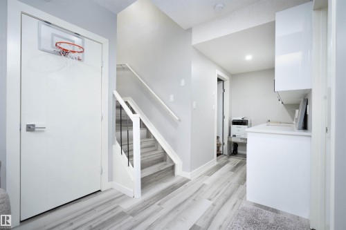 Stairway featuring wood finished floors and recessed lighting - 43 1703 16 Avenue, Edmonton, AB - Indoor Photo Showing Other Room