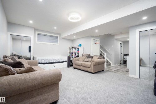 Living room featuring light colored carpet and recessed lighting - 43 1703 16 Avenue, Edmonton, AB - Indoor